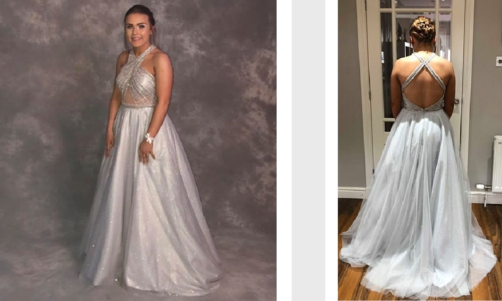 A client wears an embellished silver ballgown full skirt prom dress.